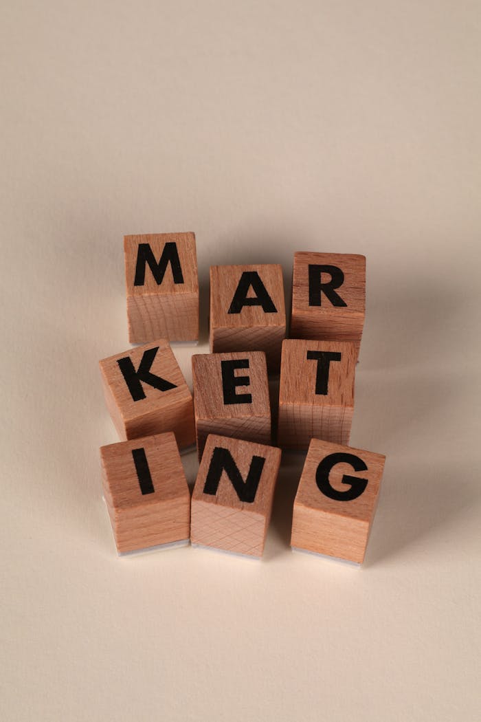 Wooden blocks arranged to spell MARKETING on a neutral background.